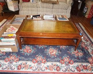 rug, books, leather top coffee table