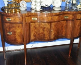 The Sideboard has 3 Drawers and Cabinet Doors that open to Storage.  The Large Middle Drawer is Lined for Flatware.