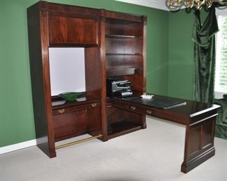 Sligh Mahogany Peninsula Unit with Center Drawer on each side.  The Desk Extends from the Wall Unit, which has 3 Adjustable Shelves above the Desk Surface, with 1 Shelf below.  W80" x H86" x D82", including the Desk.  Attached to it is Single Open Shelf Work Station with a Flip-Top Door.  There is a 24" Task Light under the Shelf, with a Fabric-Covered Tackable Surface, Drop-down Center Keyboard Drawer and a Brass Foot Rail.