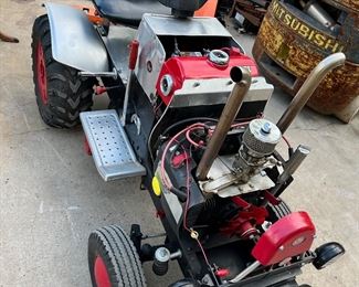 Custom Made Garden Tractor Puller, with Front and Rear Weights and a Wheelie Back Bar. ONAN 2-Stroke Engine, with High and Low Gear, 3-Speed, and Reverse. Black Cushioned Seat, Running Boards, and just a FUN little "Toy" to cruise around the neighborhood. This tractor measures 6' in length and 3' in width. FIRM PRICE $2,400.  NO DISCOUNTS on Saturday or Sunday on this item.
