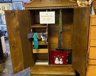 Large Carved Armoire with Pull-out-Drawers, Wire Hanging Rack, Double Doors, and Decorative Detailing