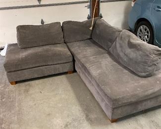 $80 Gray sectional.  Some discoloration along the back. As found.