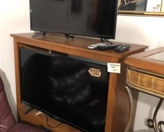 TV cabinet and some flatscreen tvs