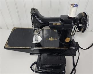 1941 Singer Featherweight sewing machine with case, keys, accessories, owners manual and extra feet.