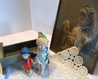 2 Porcelain Dolls, Green Wooden Crib, Doily, and Sad Girl Art