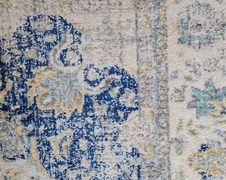 Close up of Safevieh Evoke 10' x 8' cream and blue rug in dining room 