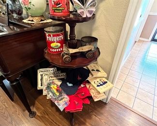 Three tier table with vintage blue bird & Camp Fire items… hats, books, song books & beads, vintage coffee & tobacco tins (great for decorating). Gorgeous stained glass 3-D butterfly