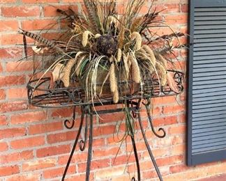 Black plant holder; copper container with arrangement