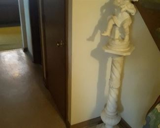 The alabaster  figure on the pedestal