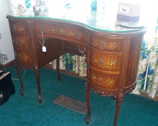 Kidney bean shaped vanity with glass top and hand painted decorative elements 