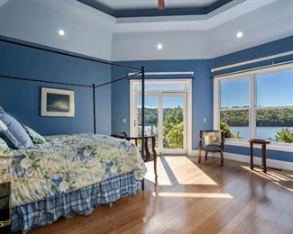 blue bedroom with king metal canopy bed frame and nice clean newer mattress