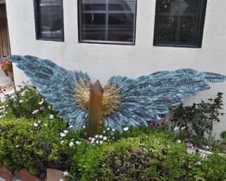 Carved wood winged torsos/figures created by David Elder.