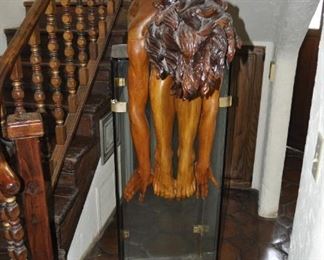 A life size carved wood artwork by Linda Elder.  Title:  PARADOX or A HARD HEADED WOMAN.