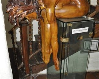 A life size carved wood artwork by Linda Elder.  Title:  PARADOX or A HARD HEADED WOMAN.