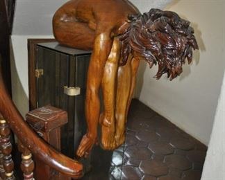 A life size carved wood artwork by Linda Elder.  Title:  PARADOX or A HARD HEADED WOMAN.