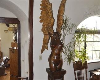 A 9 1/2 foot tall single piece  carved wood artwork by David  Elder.  Title:  Winged Victory