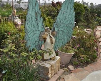 Carved wood winged torsos/figures created by David Elder.