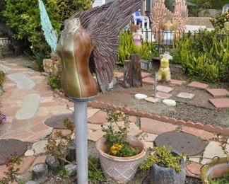 Carved wood winged torsos/figures created by David Elder.