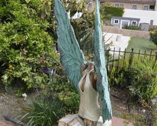 Carved wood winged torsos/figures created by David Elder.