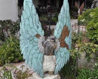 Carved wood winged torsos/figures created by David Elder.