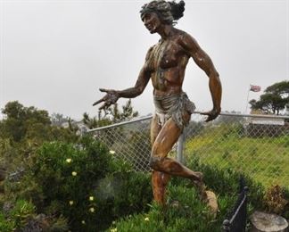 A 10 foot tall wood Chumash woman mounted on a rock created by Linda Elder overlooks the Pacific Ocean.  Title:  OXCHITL