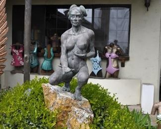 A 3 1/2 foot tall original bronze sculpture (1 of 1) by Linda Elder mounted on a 4 foot tall rock.  Title:  Crouching Woman