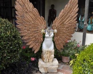 Carved wood winged torsos/figures created by David Elder.