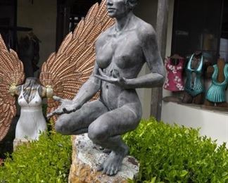 A 3 1/2 foot tall original bronze sculpture (1 of 1) by Linda Elder mounted on a 4 foot tall rock.  Title:  Crouching Woman