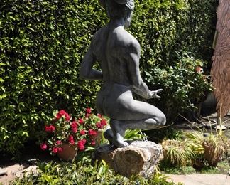 A 3 1/2 foot tall original bronze sculpture (1 of 1) by Linda Elder mounted on a 4 foot tall rock.  Title:  Crouching Woman