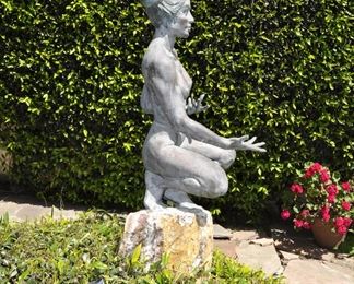 A 3 1/2 foot tall original bronze sculpture (1 of 1) by Linda Elder mounted on a 4 foot tall rock.  Title:  Crouching Woman