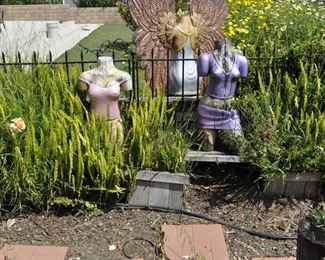 Carved wood winged torsos/figures created by David Elder.