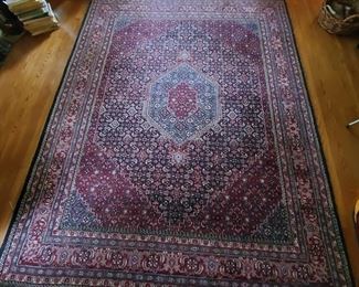 8' x 10' red and blue hues are within this gorgeous rug. Excellent condition with pad. Although the fringe is worn, as expected.