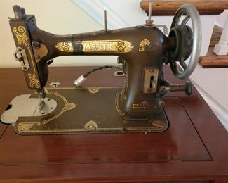Vintage sewing machine in it's table model wood cabinet