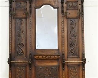 1117	LARGE ORNATE CARVED WALNUT VICTORIAN HALL ENTRY RACK ON CLAW FEET W/CARVED WINGED GRIFFINS & LIONS HEADS, BEVELED GLASS, MIRROR CENTER, APPROXIMATELY 60 IN X 98 IN HIGH
