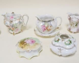 1166	R.S. PRUSSIA LOT OF SEVEN PIECES INCLUDING CREAMERS & SUGARS & COVERED BOXES. LARGEST APP. 4 IN H 
