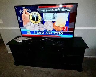 Black TV stand, large flat screen TV with great picture is SOLD