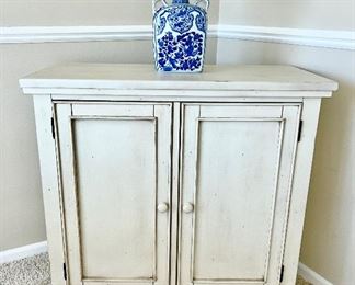 Close-up front view of French Country distressed style 2 door cabinet/chest with Linden Street label