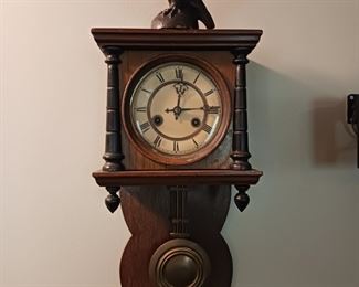 Antique wall clock with an eagle windup