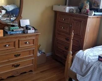 full bedroom set including wide dresser with mirror, tall dresser, bed frame, and night stand.  