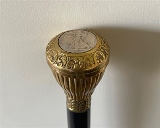 Walking stick with walking liberty half dollar