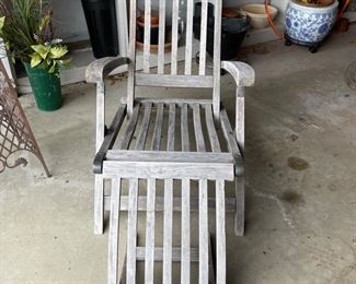 One of four teak chaise lounges