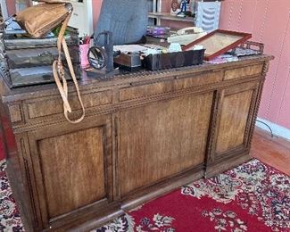 Large wooden partner desk on old Karastan rug, office chair