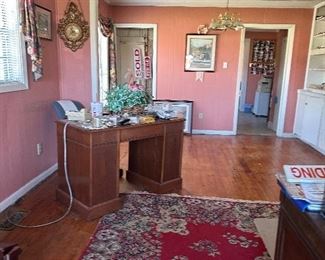 Small older wooden desk, more old rug