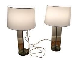 $100 USD      Pair of Glass Cylinder Lamps SO171-12     Descriptions: The simple design of these clear glass cylinder table lamps are accented with a metal trim in shimmering, nickel finish. A white drum shade and a steel finish finial top off this distinctive design perfect for any decor.

Dimensions: 6 x 6 x 27"H 

Condition: Good condition.  Used solely for home staging.  Please check photos for nicks or wear.  We do our best to disclose any flaws. 

Location:  Located in NW Washington, D.C.  Contact us for shipper suggestions.     https://goodbyhello.com/products/pair-of-glass-lamps-so171-12?_pos=7&_sid=b8df54176&_ss=r