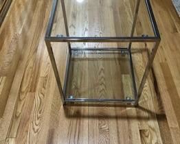 $200 USD    2 Modern 2-Tiered Chrome & Glass Square End Tables/Night Stands SO171-11      Desription: Stylish and timeless contemporary chrome and glass two tier end tables.  Adds light to dark or smaller spaces. 

Dimensions: 18 x 18 x 22"H  

Condition: Good condition.  Used solely for home staging.  Please check photos for nicks or wear.  We do our best to disclose any flaws. 

Location:  Located in NW Washington, D.C.  Contact us for shipper suggestions.    https://goodbyhello.com/products/pair-of-square-glass-end-tables-night-stands-so171-11?_pos=47&_sid=b8df54176&_ss=r    