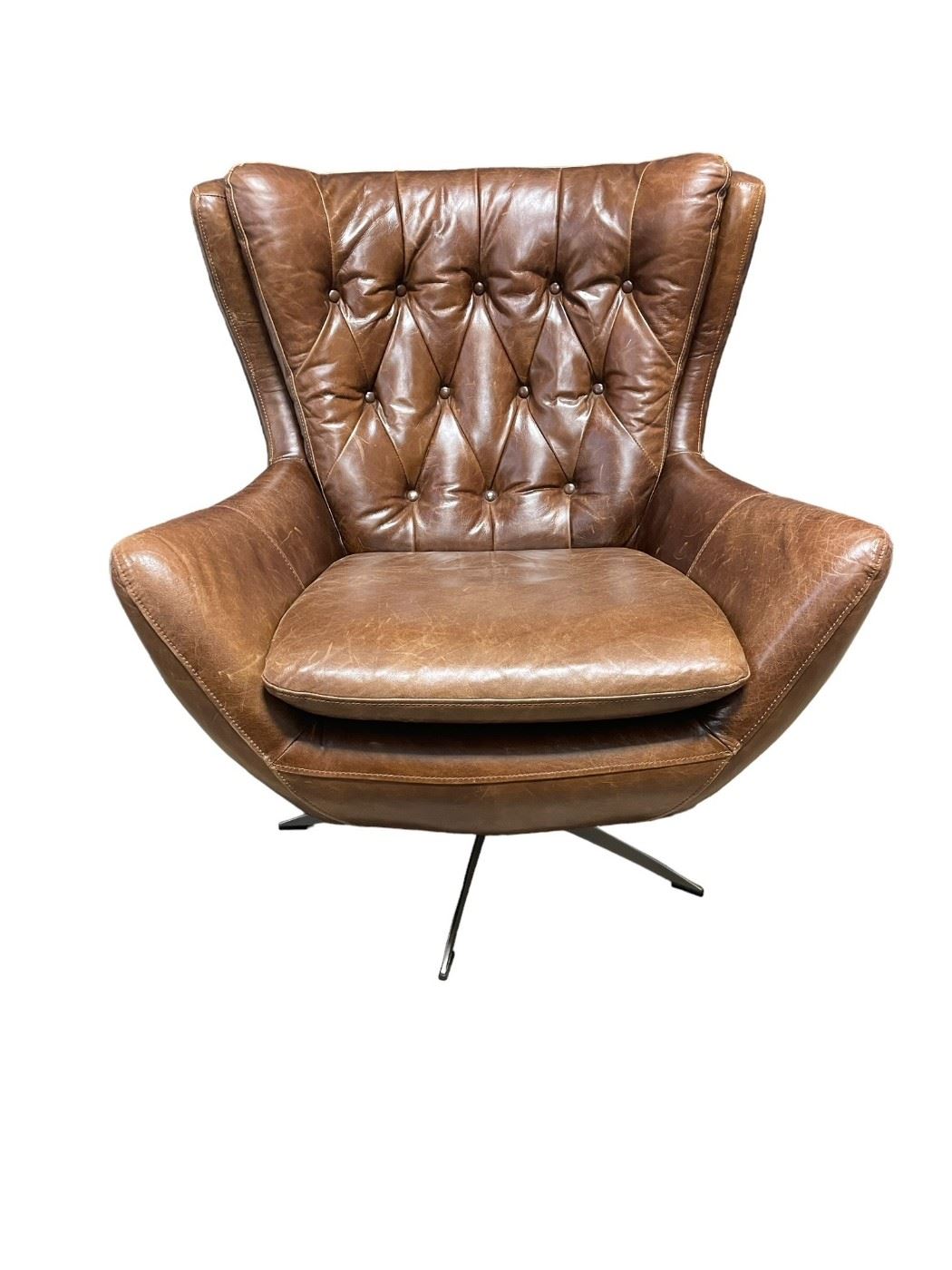 $1000 - Pottery Barn Brown Swivel Leather Tufted Back Chair HR177-10                                                                                             According to the Pottery Barn website: "A swivel chair couldn't get more inviting than this. Plush and roomy, [the] Wells Leather Tufted Armchair is wrapped in top-grain leather for sink-in comfort. Rich leather creates a beautiful counterpoint to the exposed metal base. The modified wingback design makes a statement in any space. The versatile swivel base lets you move swiftly between vantage points." Its rich molasses leather brings the old-school charm and comfort, but the brushed nickel base modernizes the look of this bestseller. Note that this chair is made from real leather, which will show scratches and wear over time, which builds its personality. "Our leathers appeal to customers who find the natural color variations, markings and patina of pure aniline leathers unique and beautiful. They may not appeal to customers w