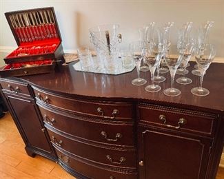 Gorgeous  mahogany sideboard  with brand new Mikasa  stems  and ice  bucket.  Also  included are Mignon Faget "on the rocks" glasses  and a nice set of flatware (not sterling) 