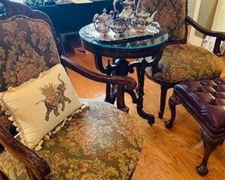 upholstered  chairs and a precious  round top table