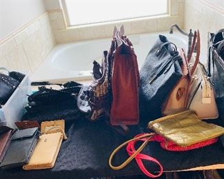 several  slightly used or brand new lady's  handbags