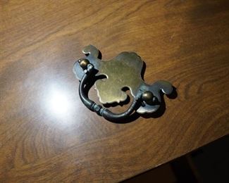 Brass knocker found inside drawer of oak double dresser